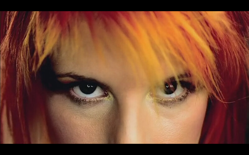 close-up of eyes with colorful hair