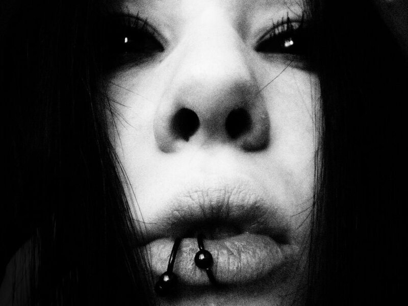 close-up of face with lip piercing