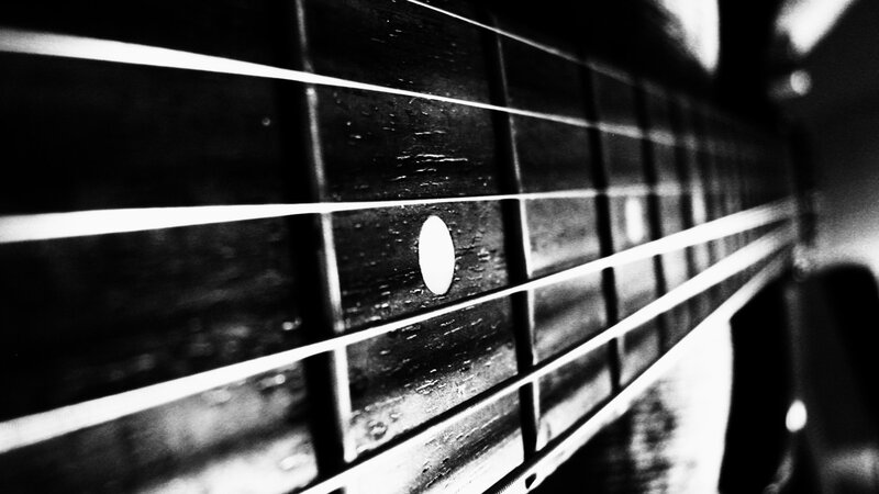 Close-up of Guitar Fretboard — Black, Dramatic
