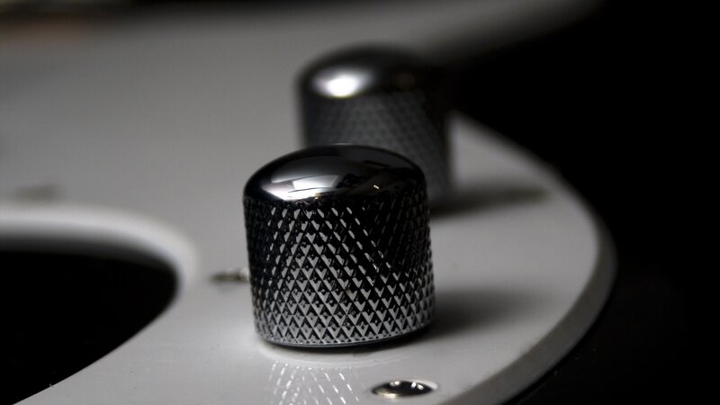 close-up of guitar knobs