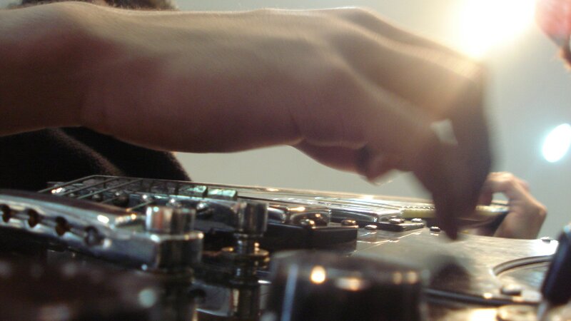 close-up of hands on guitar