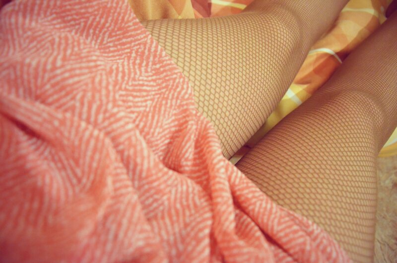 close-up of legs in fishnet tights