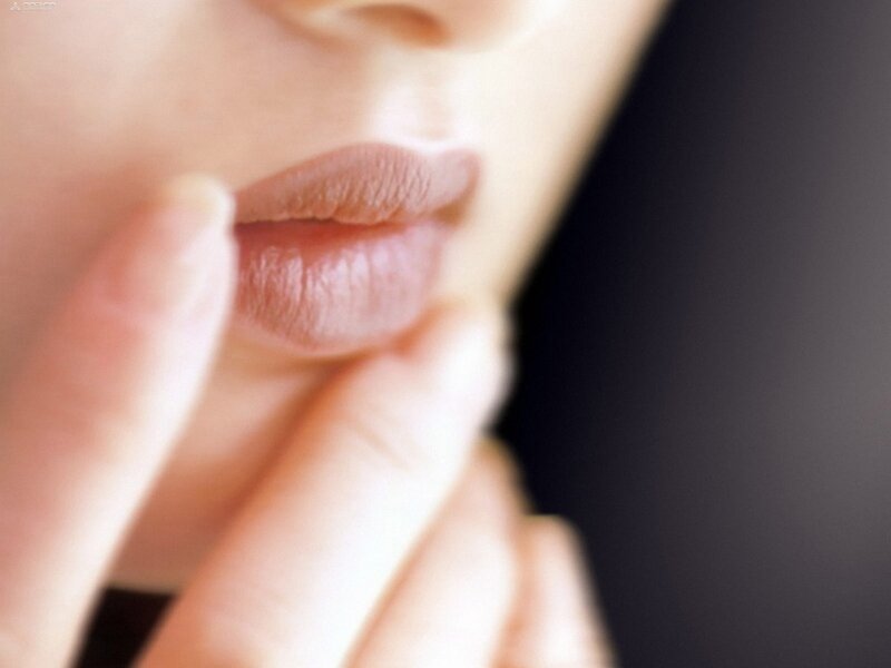close-up of lips and hand