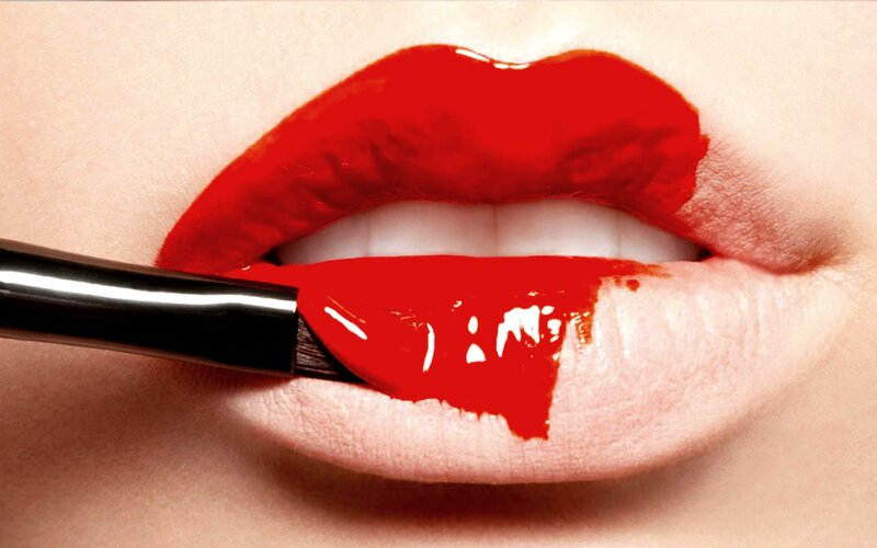 Close-up of Lips Applying Lipstick — Red, Dramatic