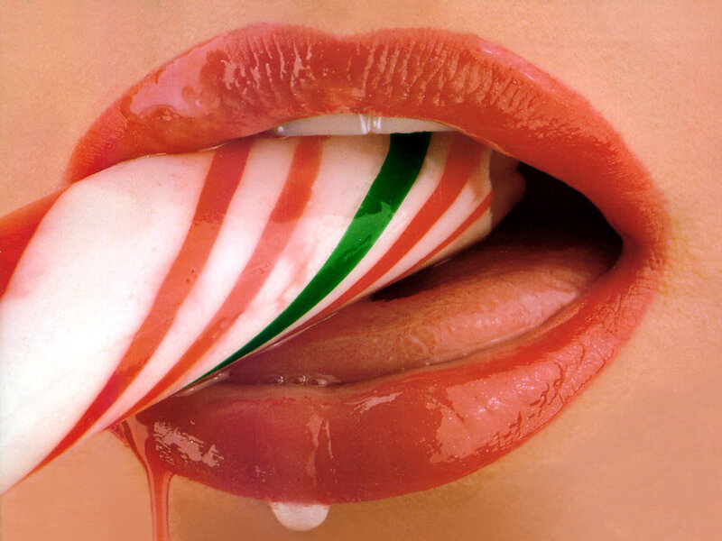 close-up of lips with candy cane