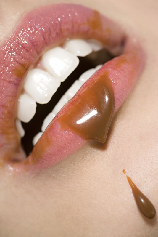 close-up of lips with caramel