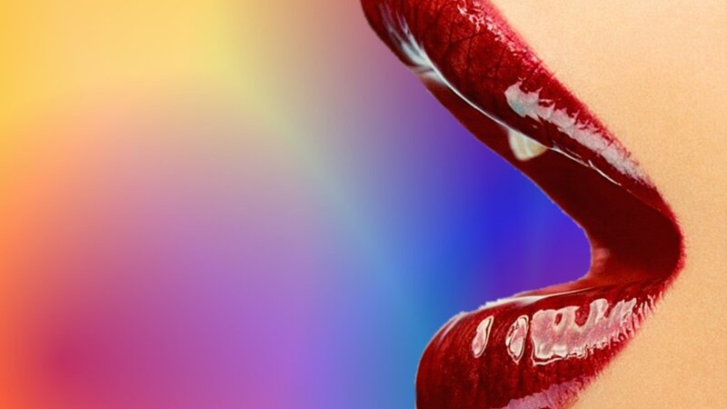close-up of lips with colorful background
