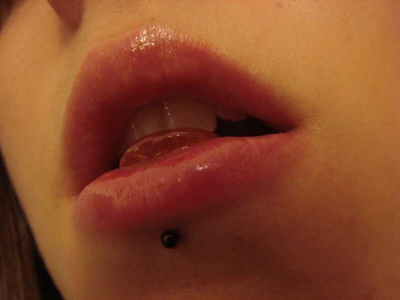 close-up of lips with lip piercing