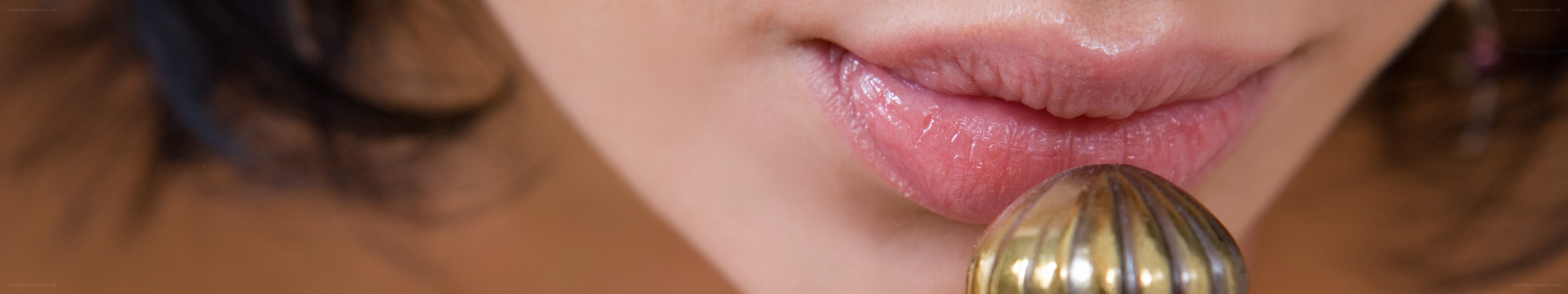close-up of lips with object