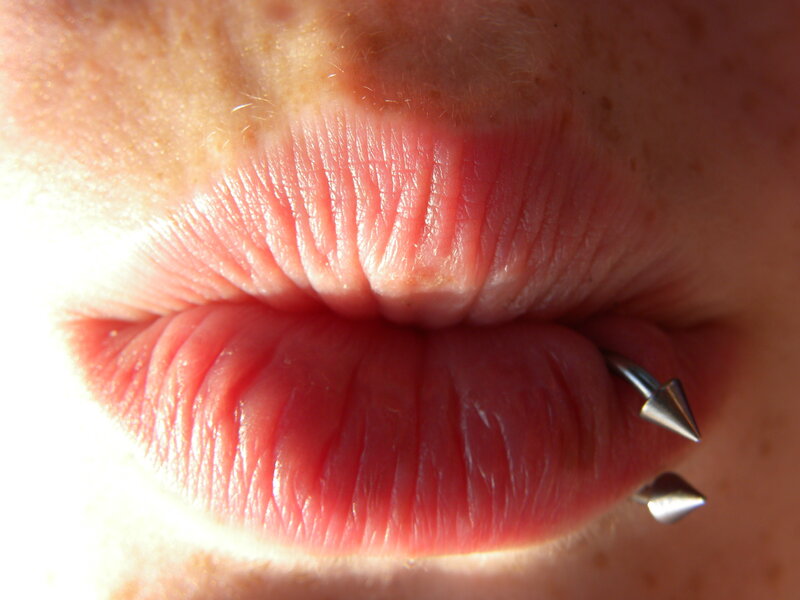 close-up of lips with piercing