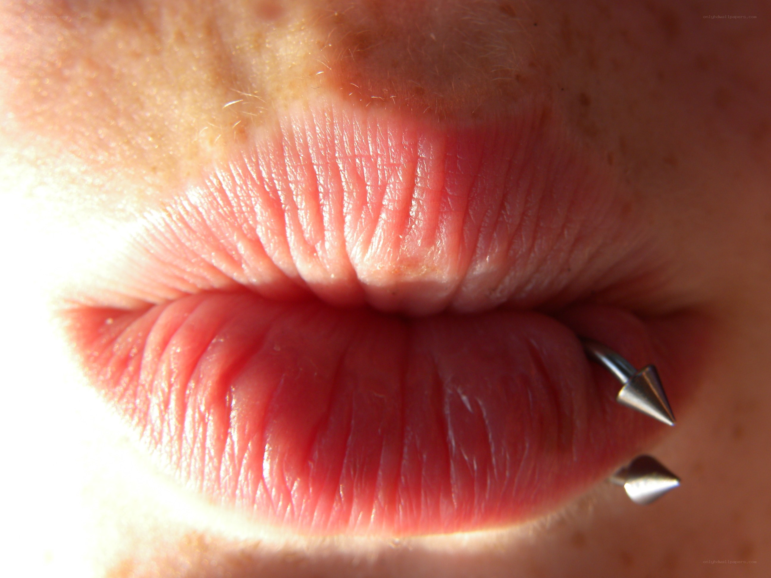 close-up of lips with piercing