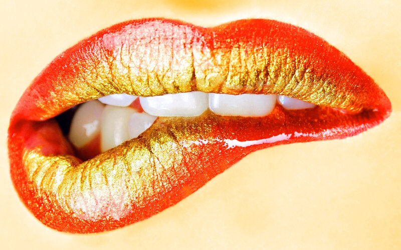 close-up of lips with red and gold makeup