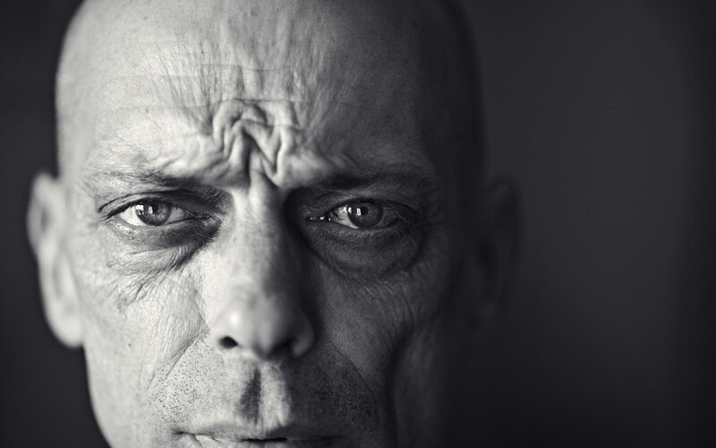 Close-up of Man's Face — Black, Dramatic, Photograph, Eyes, Bald Head