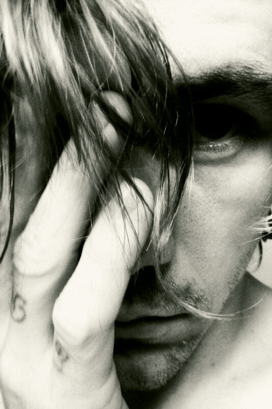 close-up of man with hand on face