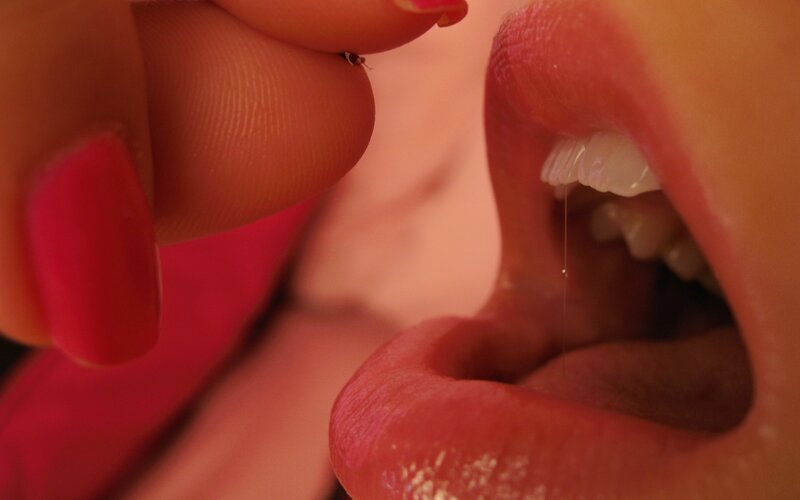 close-up of mouth and hand