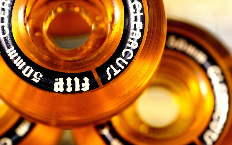 Close-up of orange skateboard wheels