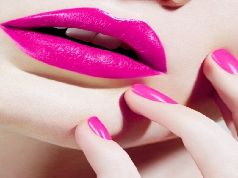 close-up of pink lips and nails