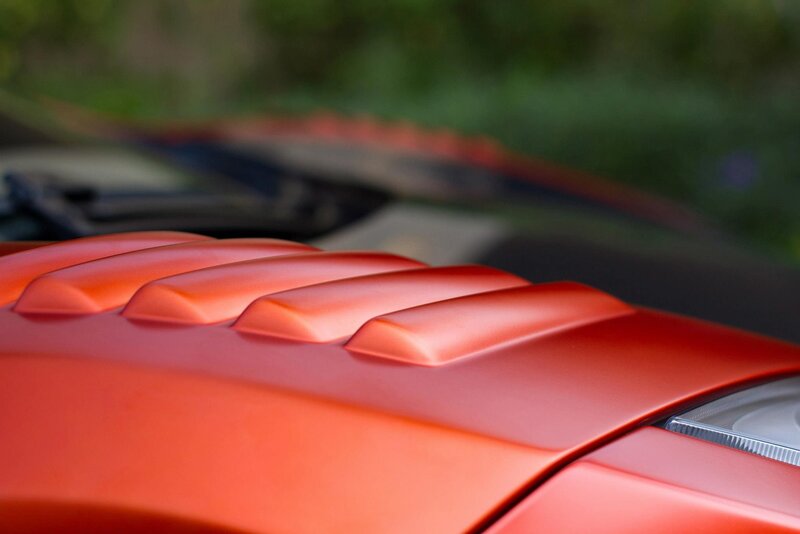 Close-up of red car hood vents