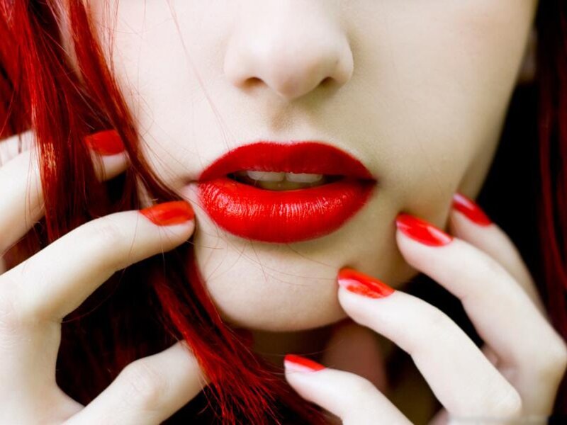 close-up of red lips and nails