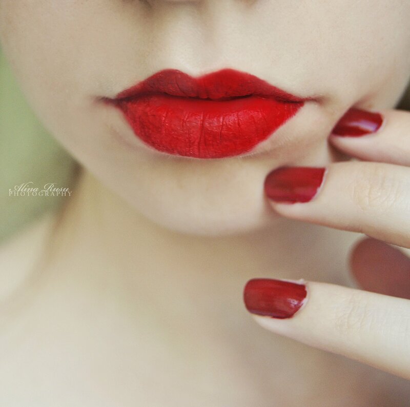 close-up of red lips and nails