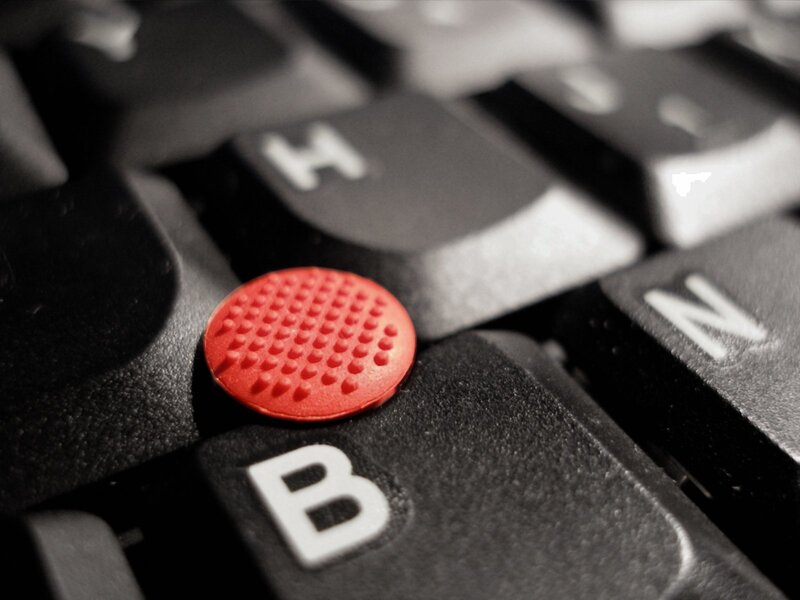 close-up of red trackpoint on keyboard