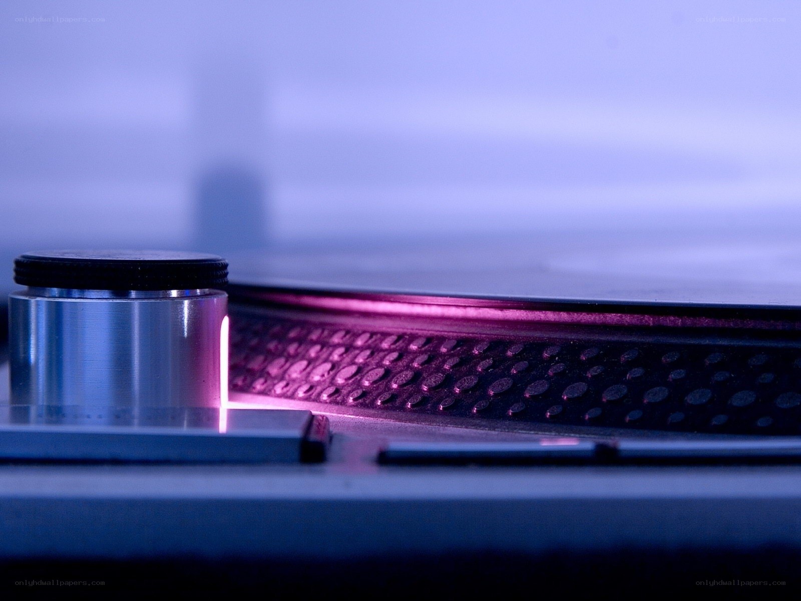 Close-up of turntable with purple light