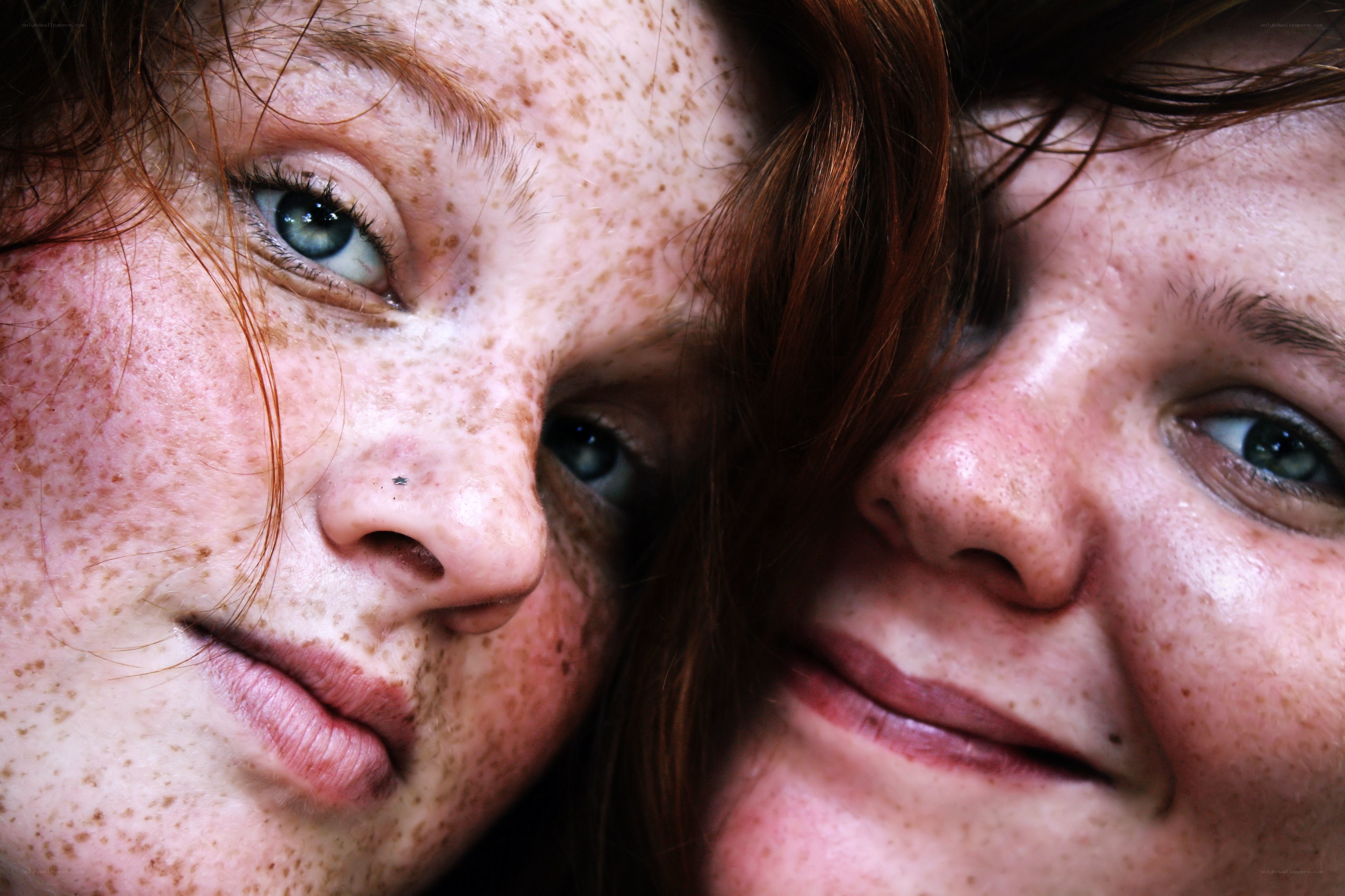 Close-up of two freckled faces