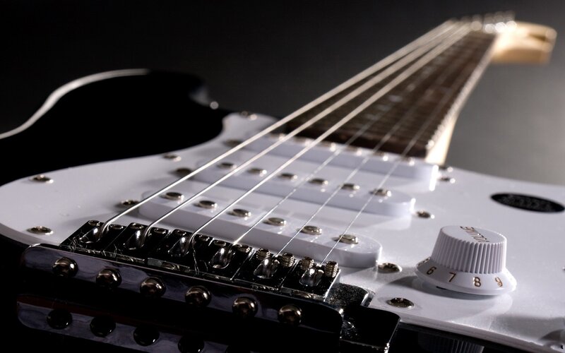 close-up of white electric guitar