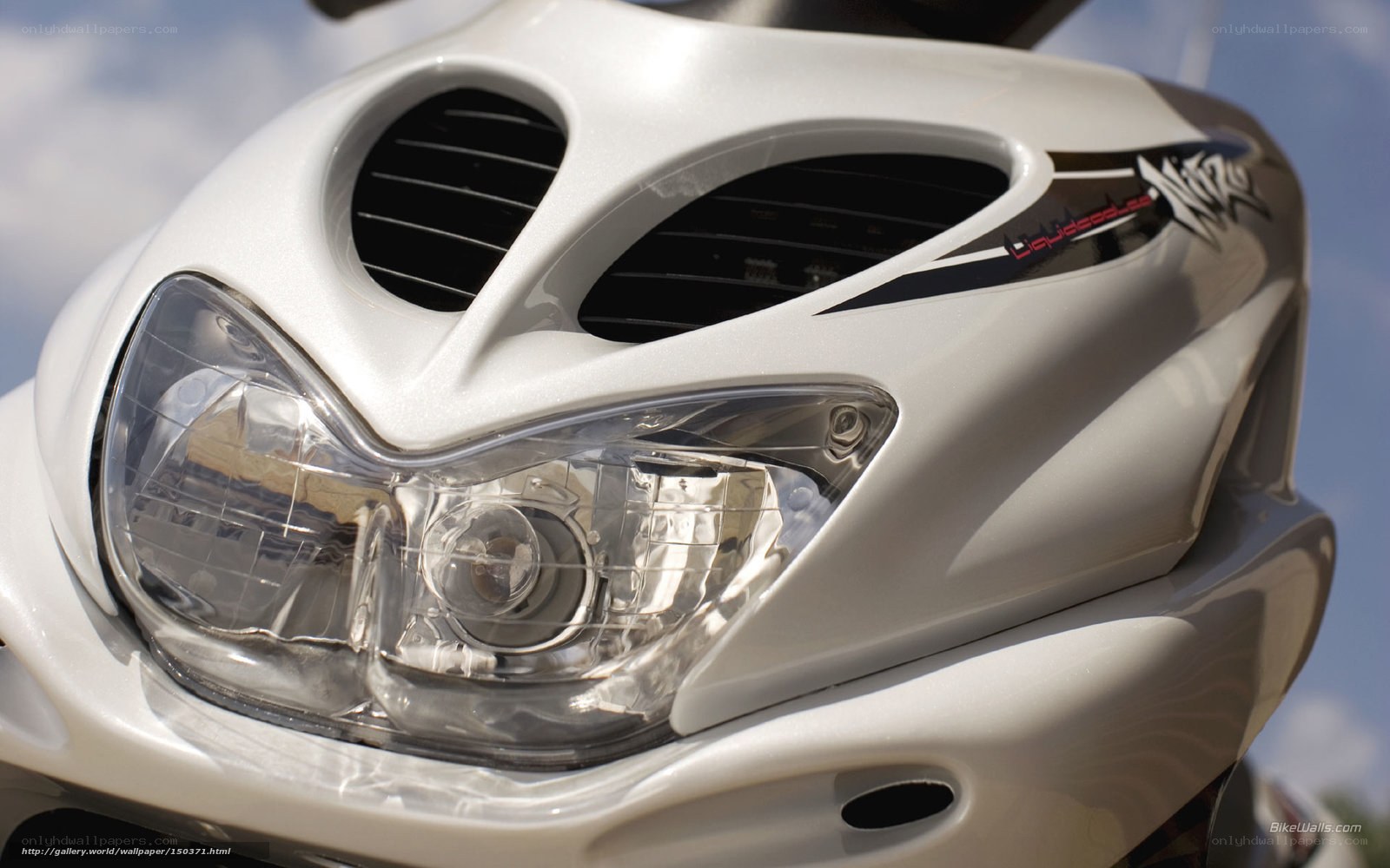 close-up of white scooter headlight