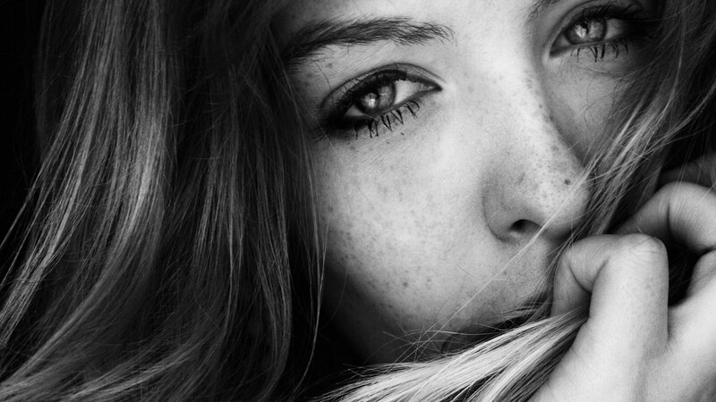 Close-up of Woman's Face — Black, Dramatic, Photograph, Hair, Eyes, Hand, White