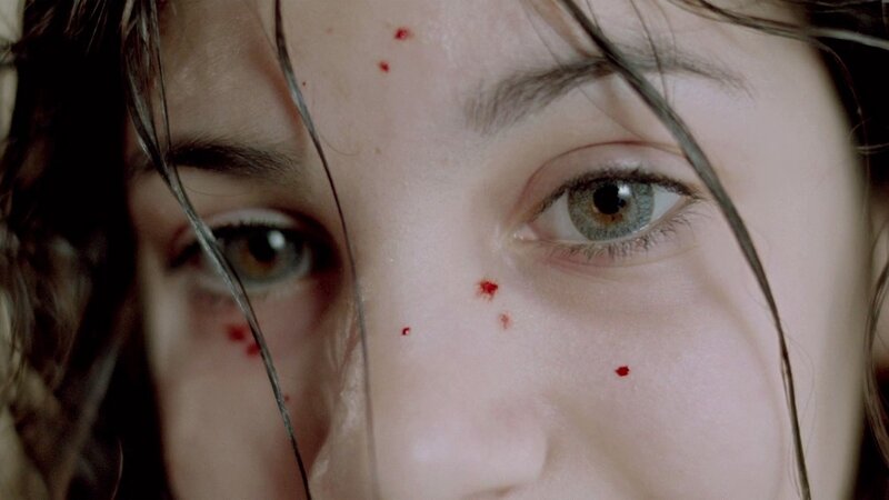 close-up of woman with blood on face