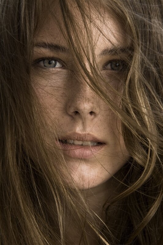 close-up of woman with wind-blown hair