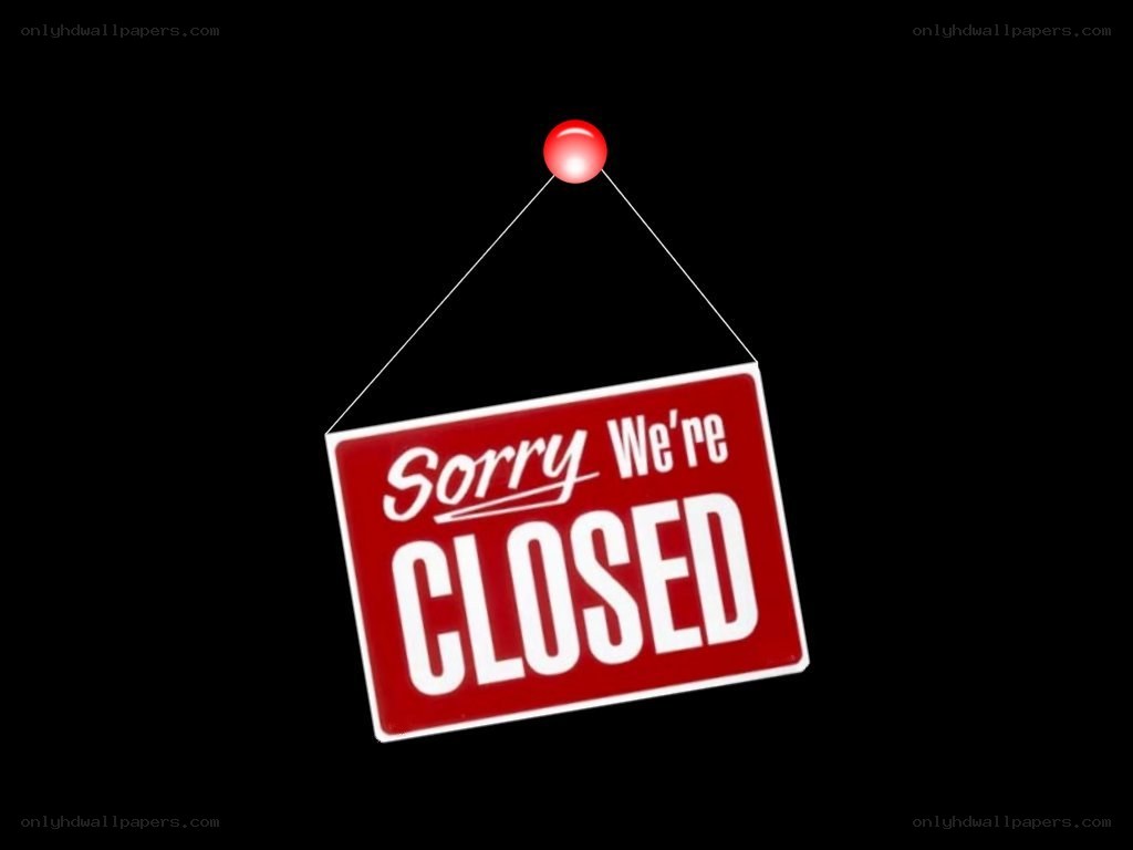 Closed sign hanging on black background