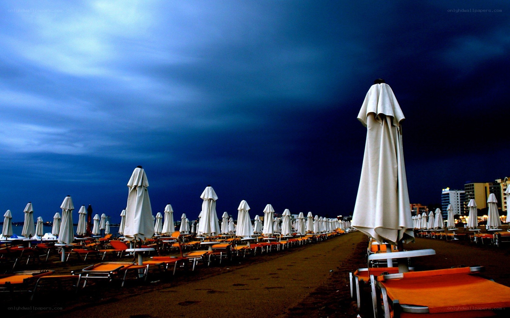 Closed umbrellas on a stormy beach