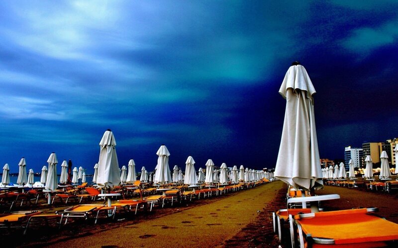 Closed Umbrellas on Beach