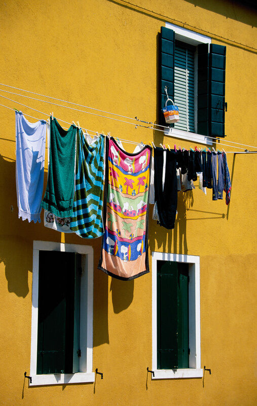 Clothes drying on a yellow wall