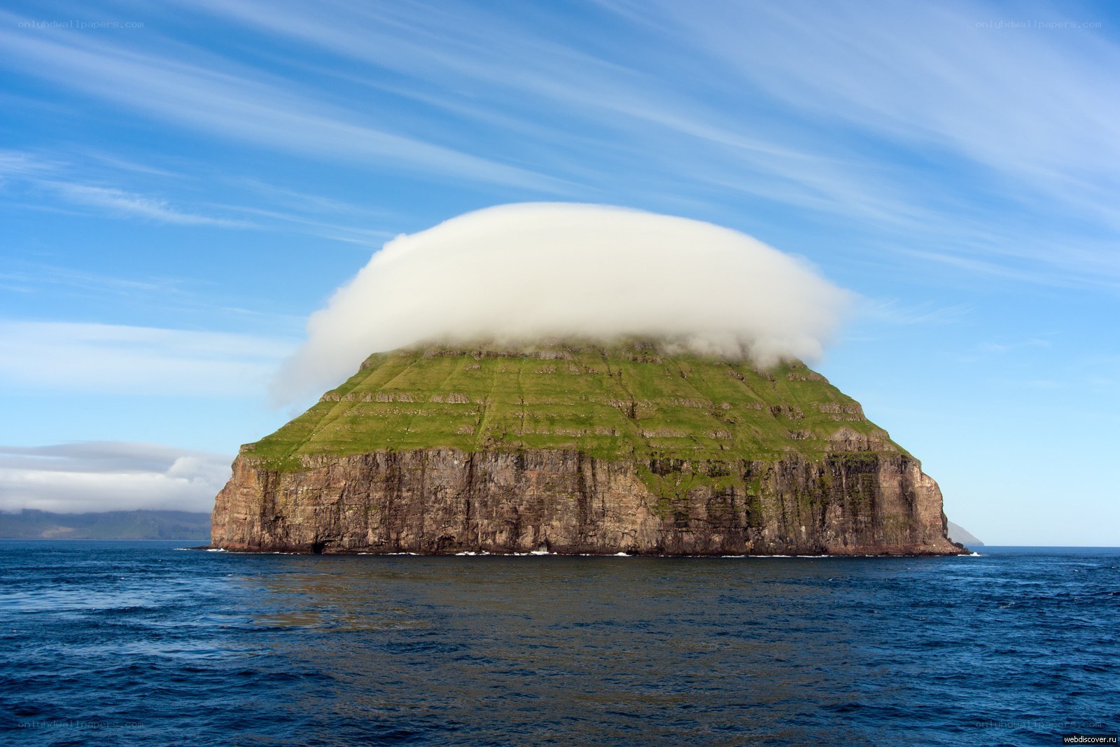 Cloud-covered island in the ocean