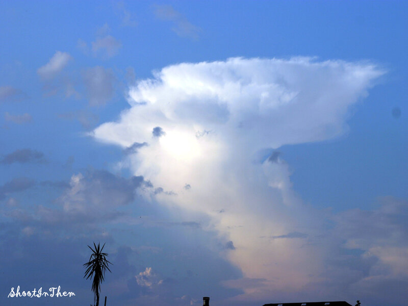 Cloud formation over rooftops