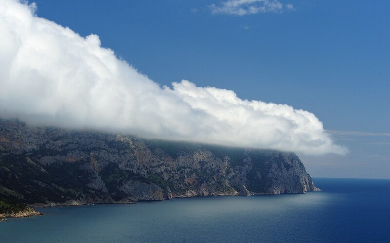 Cloud over coastal cliffs