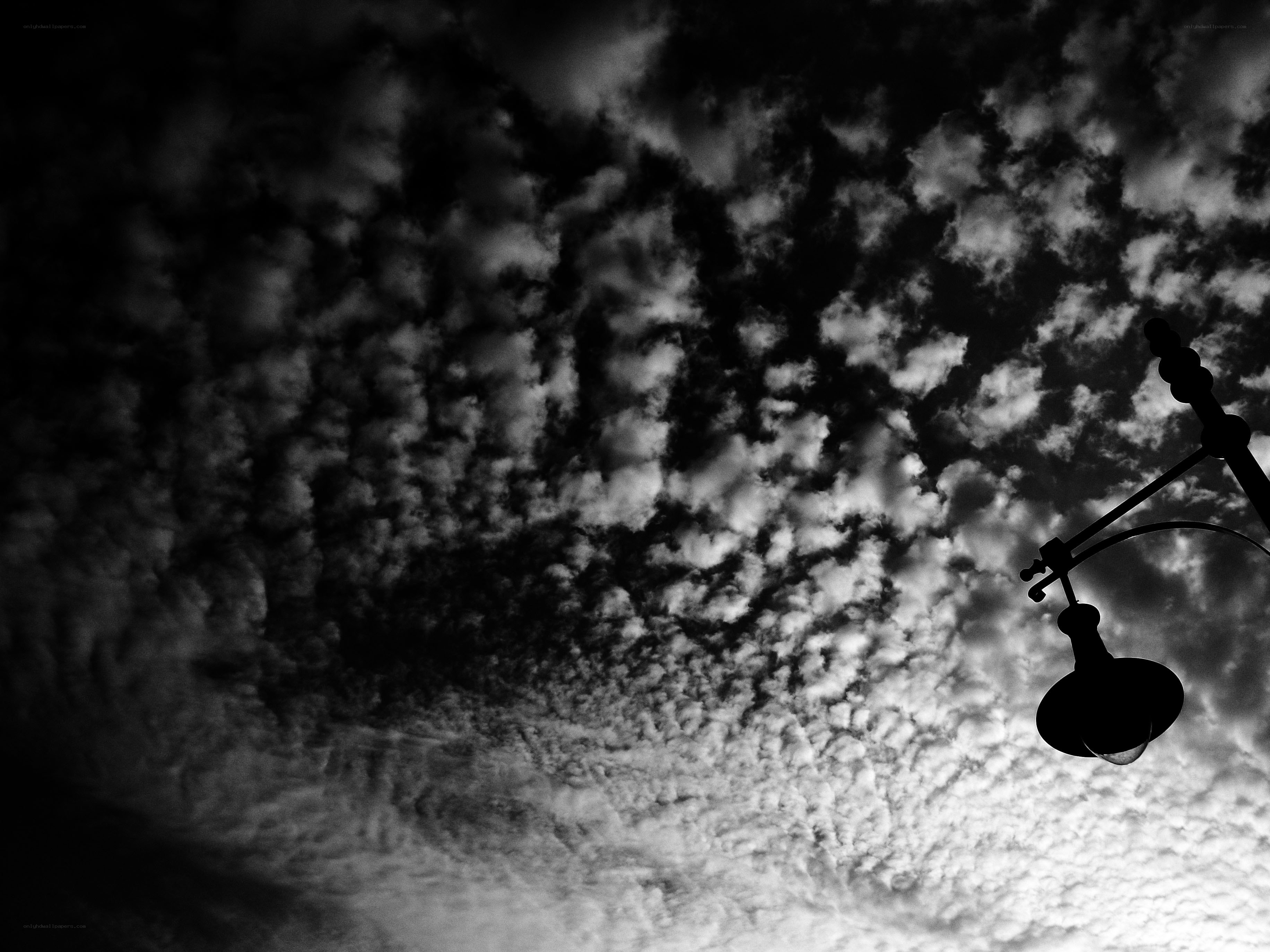Clouds and street lamp silhouette