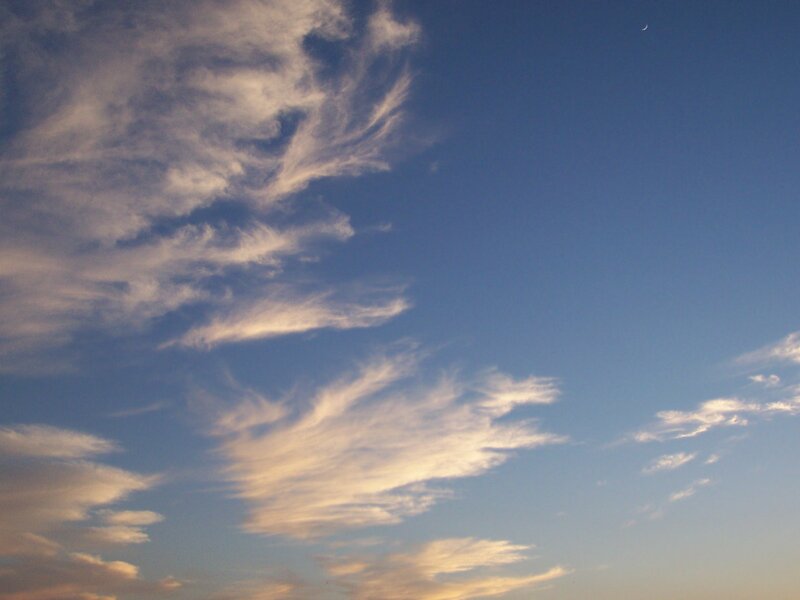 Clouds at dusk with crescent moon