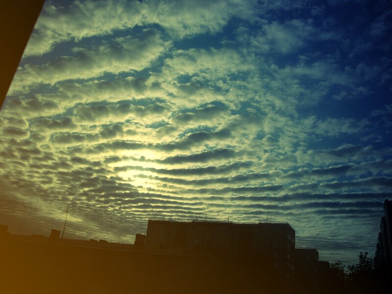 Clouds at sunrise over buildings
