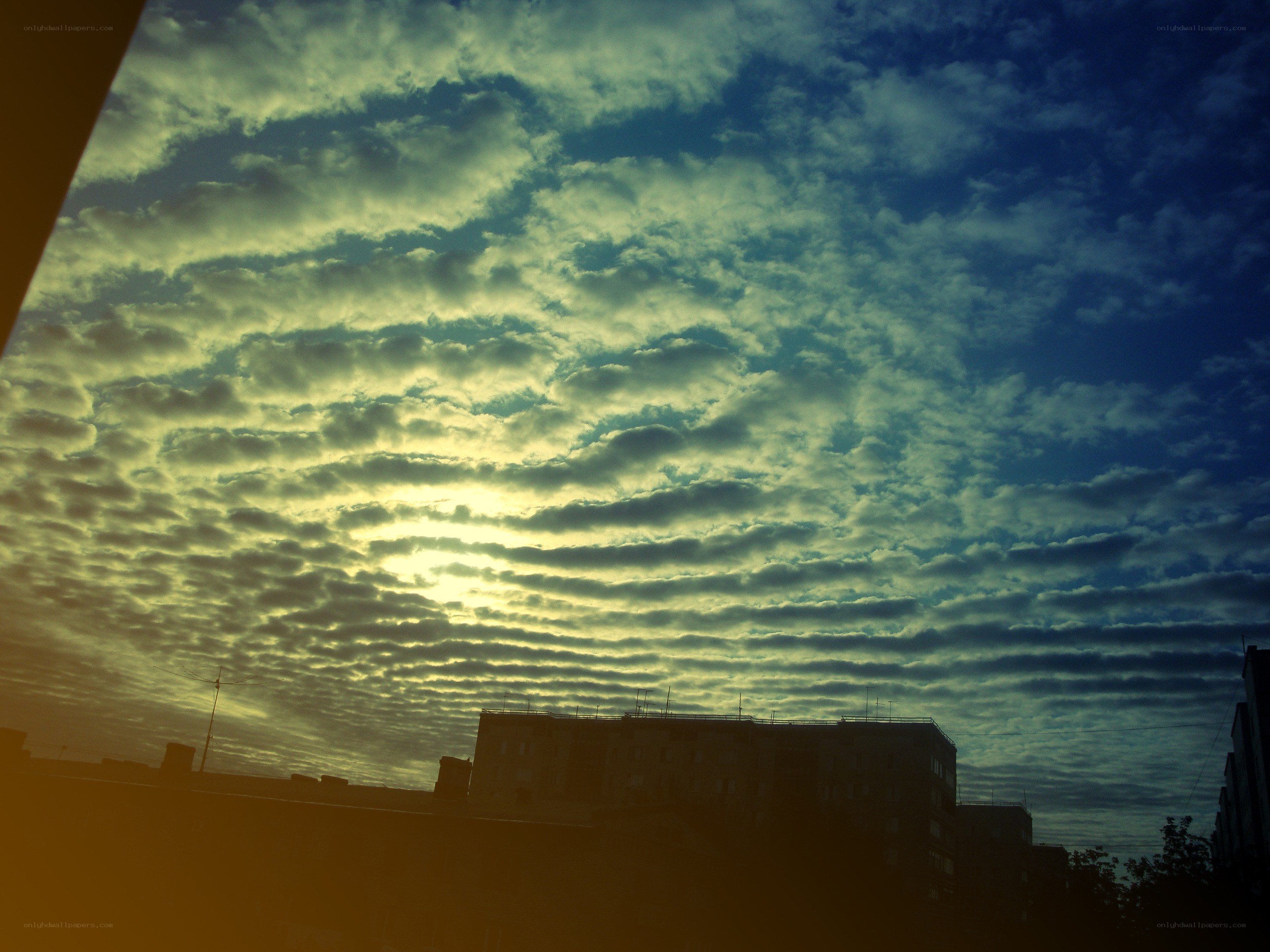 Clouds at sunrise over buildings