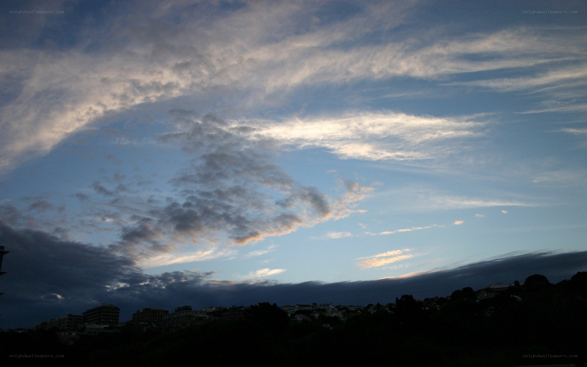 clouds over a city at dusk