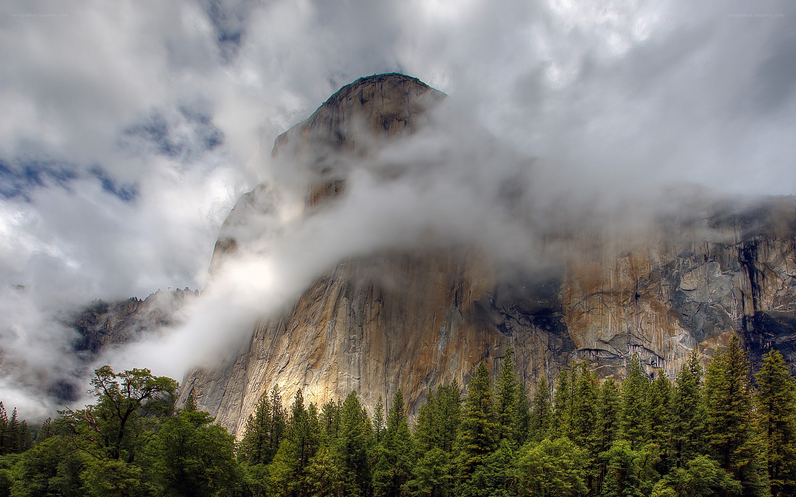 Clouds over a mountain peak