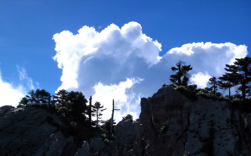 Clouds over a rocky mountain