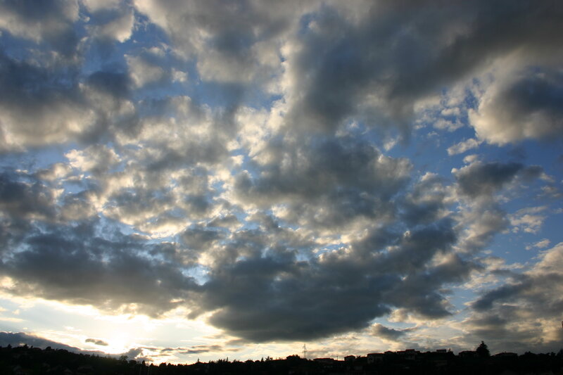 Clouds over a town at sunset