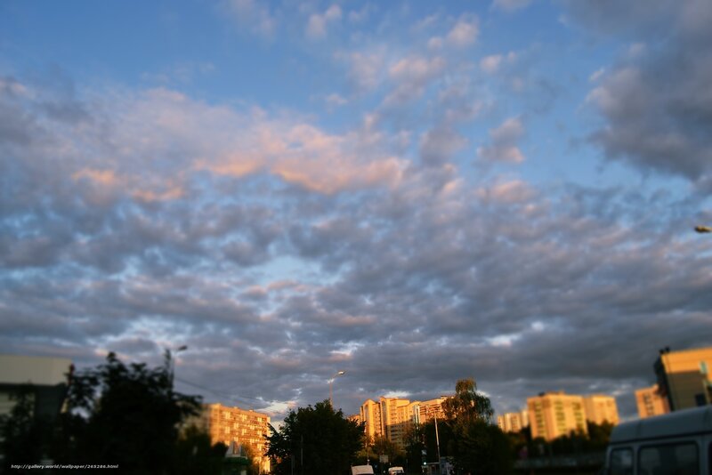Clouds over city at sunset