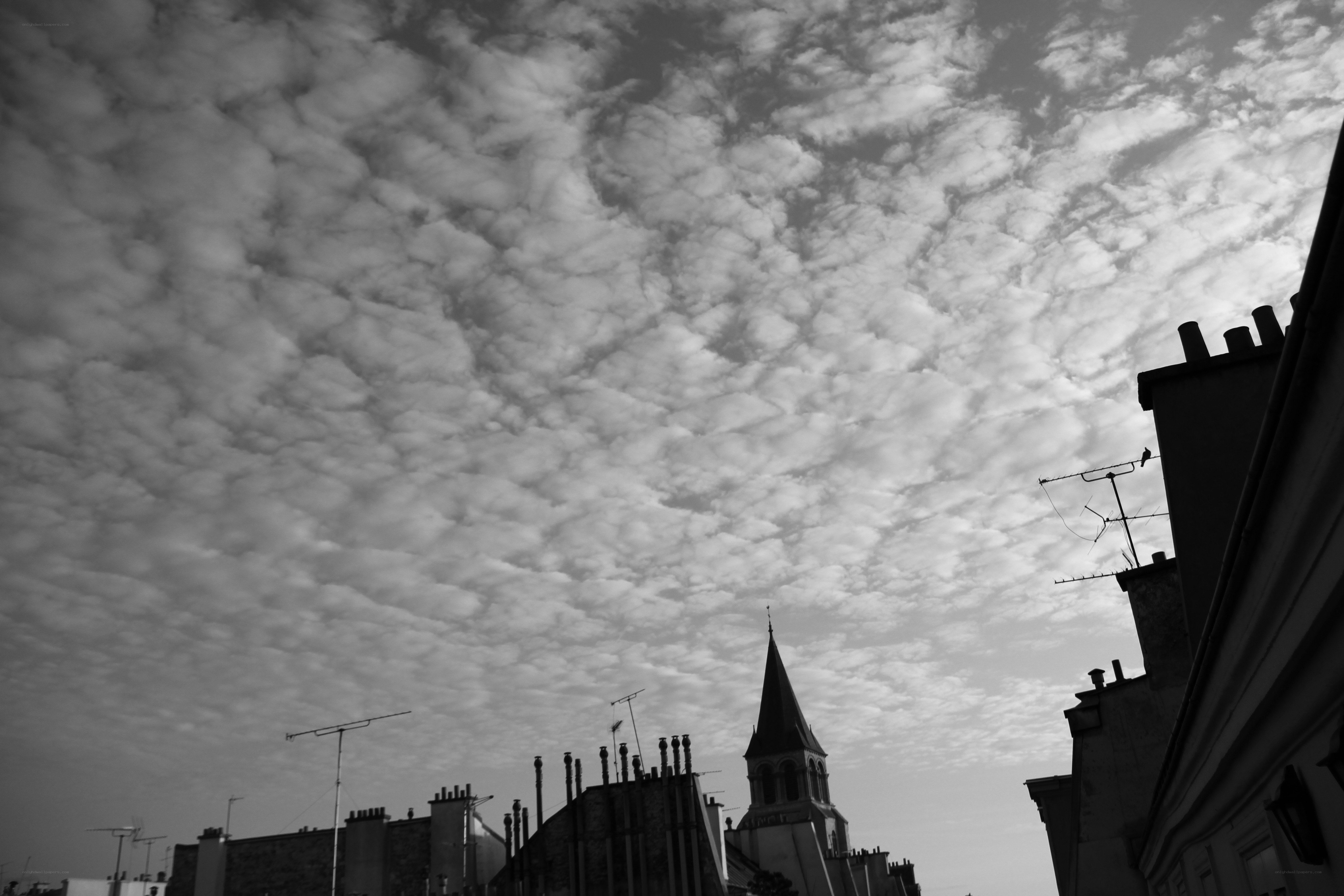 Clouds over city rooftops