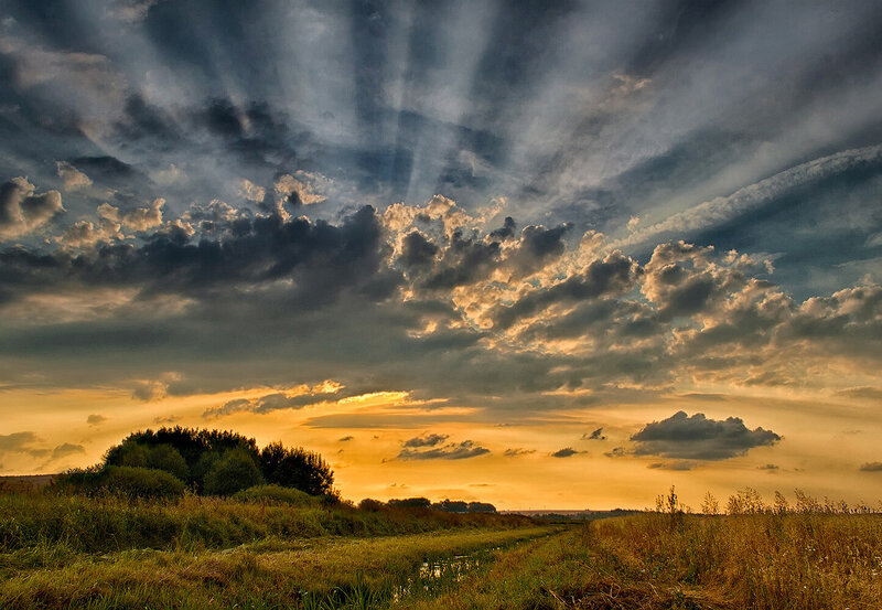 Clouds over Field at Sunset